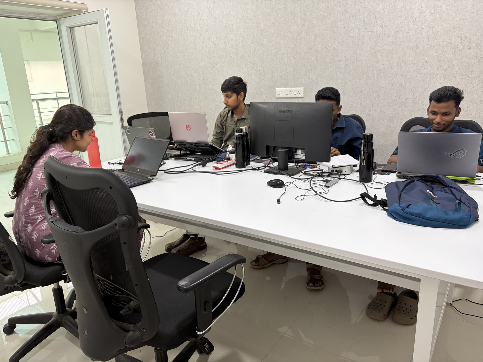 Students and mentors collaborating in a modern innovation workspace